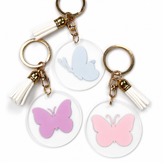 Trois porte-clés prénom papillon en acrylique bleu, mauve et rose avec pompon - EDISAMP